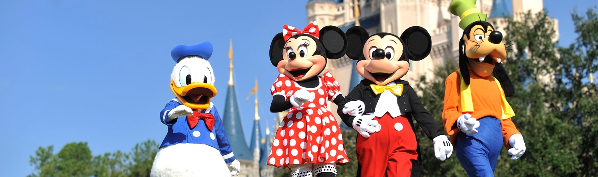 Characters Donald Duck, Minnie Mouse, Mickey Mouse and Goody near Cinderella Castle at Magic Kingdom park