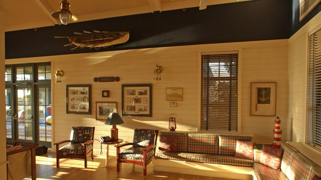 Disney S Hilton Head Island Resort Vacation Club A Living Room With Pale Wood Walls And Floors Sofas Armchairs Patio