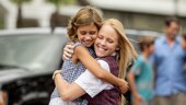A girl hugs a Disney Cast Member