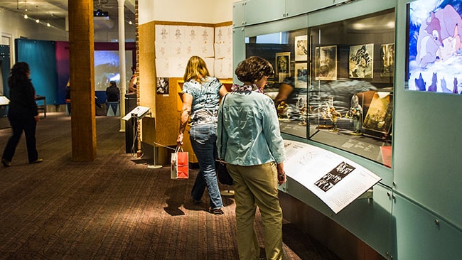 Women looking at displays of animation cels at The Walt Disney Family Museum in San Francisco